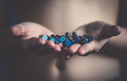 Woman holding blue beads