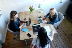 Three women co-working at a table