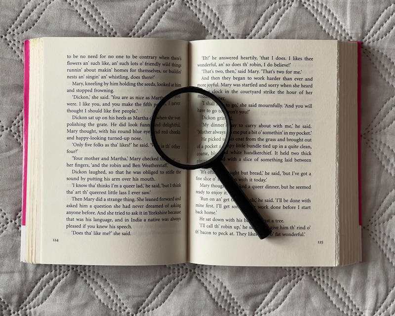 A magnifying glass lying on an open book